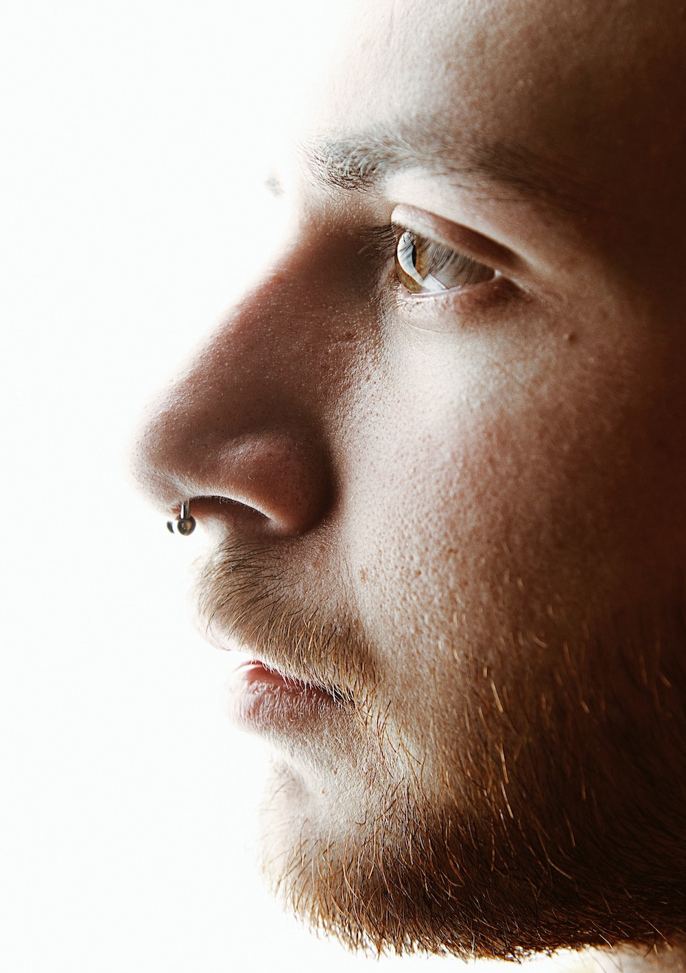Profile of man with septum piercing