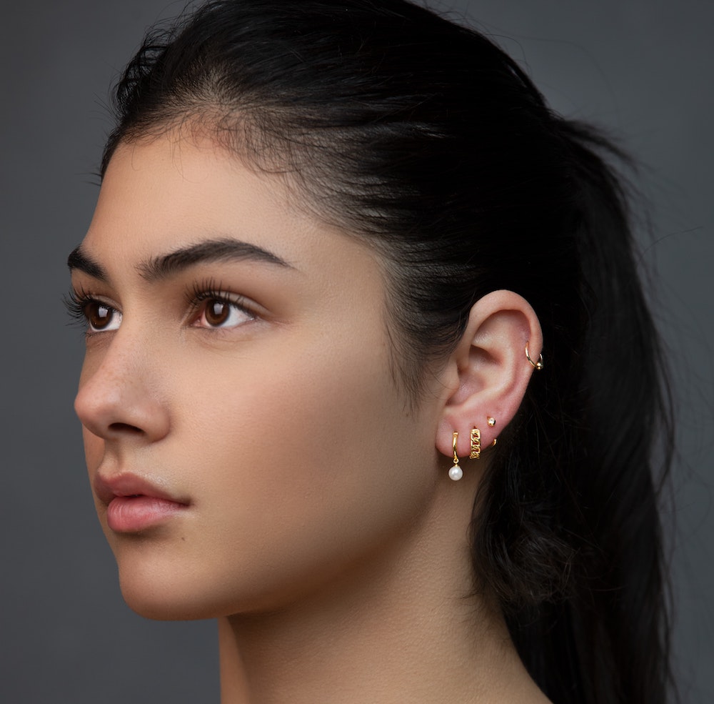 woman with multiple lobe piercings